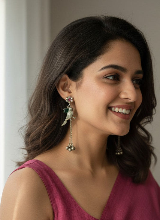 Model wearing Silver Oxidized Bird Motif Earrings with Ghungroo Drops & Green Stone Accent for Women - All Occasions