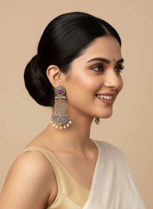 Model wearing Silver Oxidized Dangler Earrings with Pearls and Pink Monalisa Stones for Women - Occasion Wear