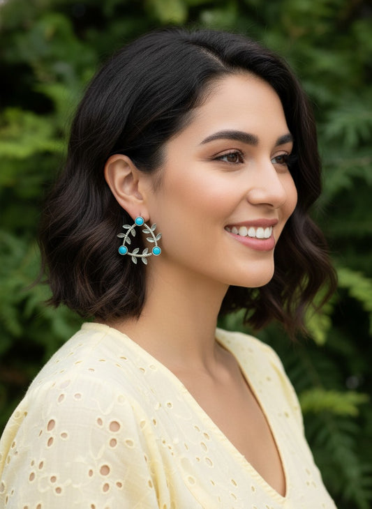 Model wearing Silver Oxidized Geometric Pattern Leaf-Inspired Earrings in Turquoise stones for Women - Everyday Office Casual Wear