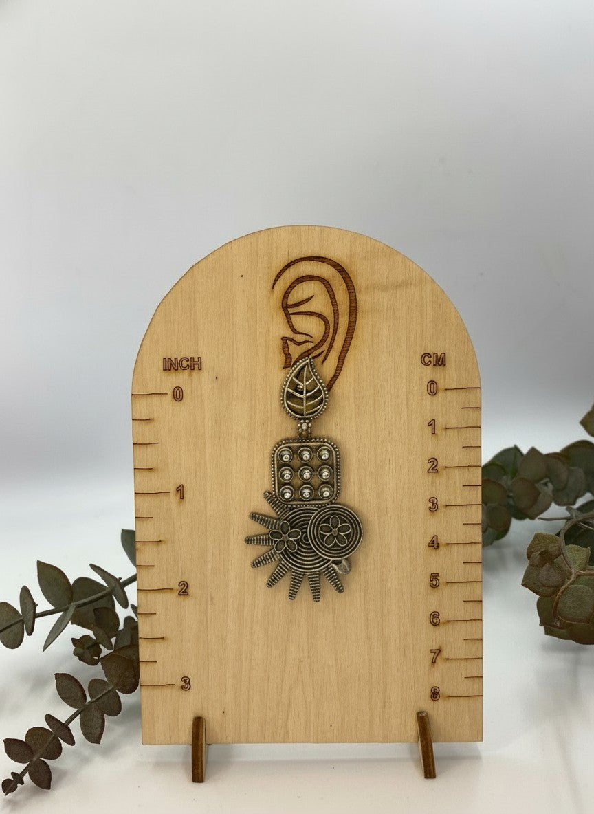 antique silver oxidized earrings on measurement scale for sizing