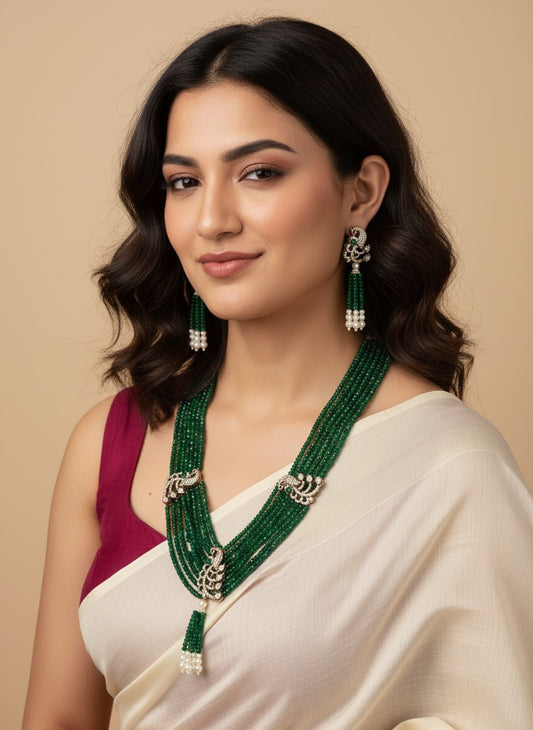 Woman wearing a green necklace and earrings on a beige background