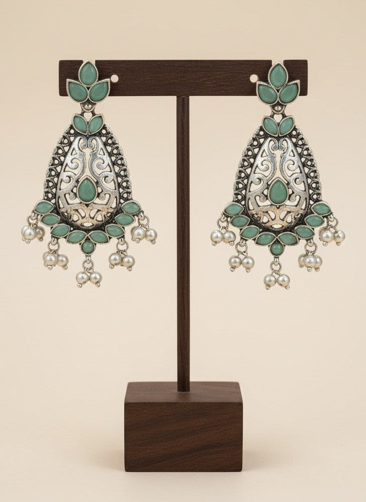 On a display stand Silver Oxidized Filigree Teardrop Earrings with Mint Stones & Pearl Drops for Women - Festive Wear