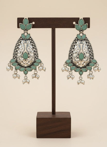 On a display stand Silver Oxidized Filigree Teardrop Earrings with Mint Stones & Pearl Drops for Women - Festive Wear