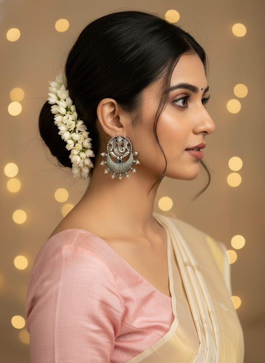 Model wearing Silver Oxidized Ganesha Motif Stud Earrings with Intricate Detailing for Women - Special Occasions 