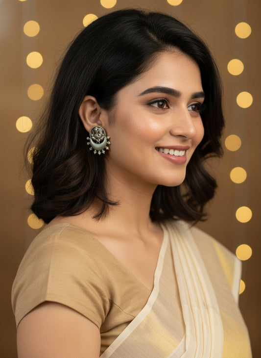 Model wearing Silver Oxidized Ganesha Motif Stud Earrings with Intricate Detailing for Women - Special Occasions