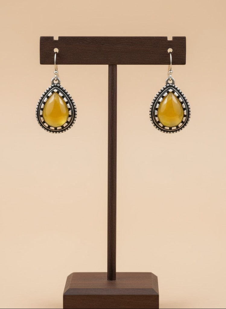 On a display stand Silver Oxidized Teardrop Yellow Stone Hook Earrings with Beaded Detailing for Women - Everyday Wear