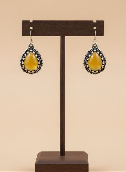 On a display stand Silver Oxidized Teardrop Yellow Stone Hook Earrings with Beaded Detailing for Women - Everyday Wear
