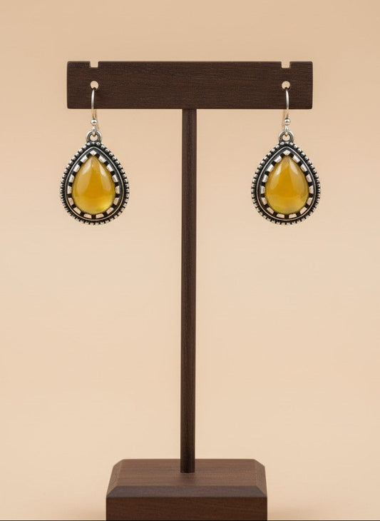 On a display stand Silver Oxidized Teardrop Yellow Stone Hook Earrings with Beaded Detailing for Women - Everyday Wear