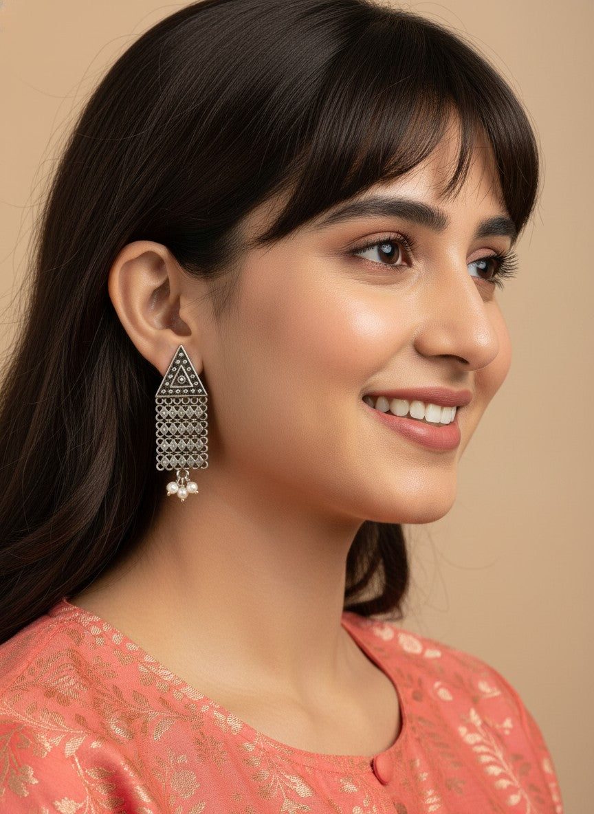 Model wearing Silver Oxidized Tribal Triangle Drop Earrings with Chain Tassels & Pearl Drops for Women - Everyday Wear